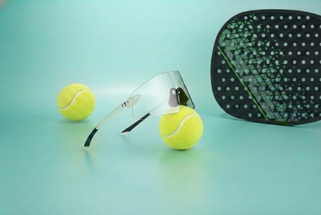 Padel rocket with two padel balls and Tifosi Padel Sunglasses