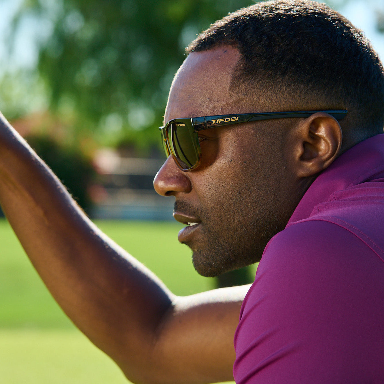 Close up on side view of man on golf course wearing sunglasses