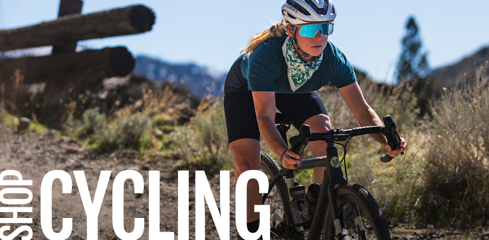 Woman cycling on a trail with text overlay 'Cycling' in a mountainous area.