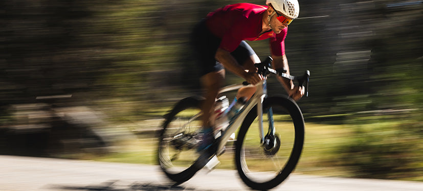 Male cyclist going downhill wearing shield sunglasses