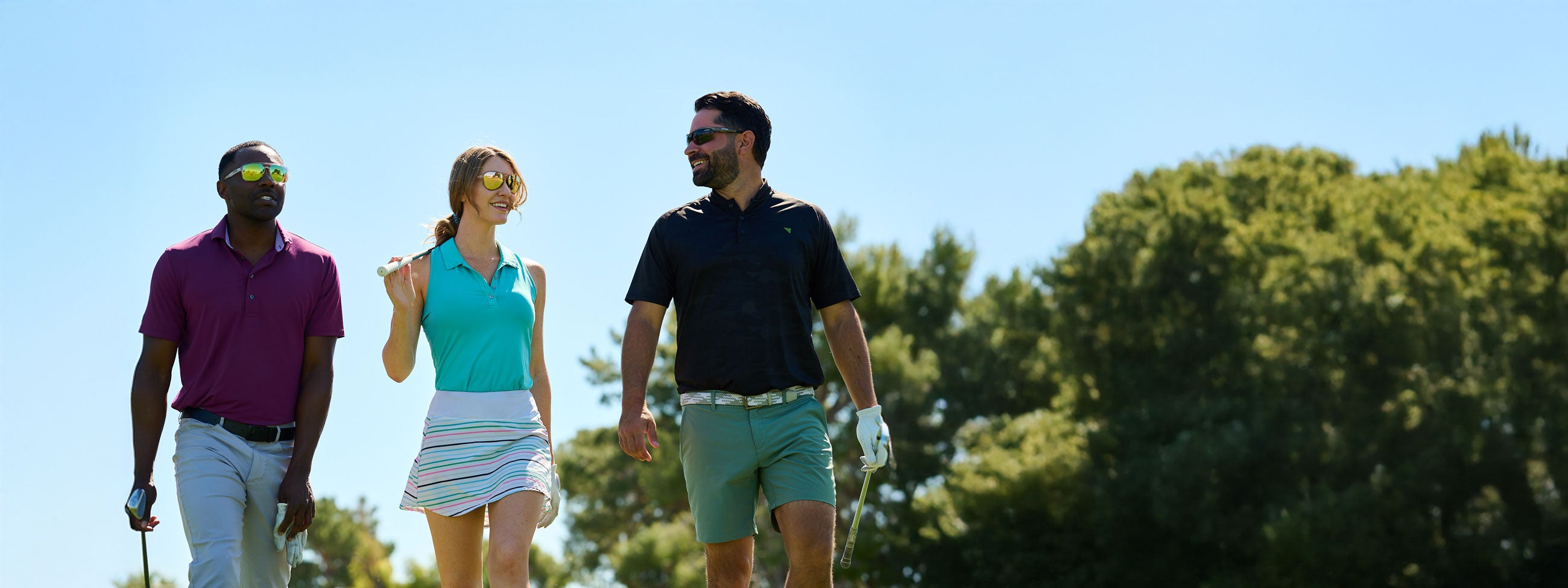 Two men and one women, on golf course