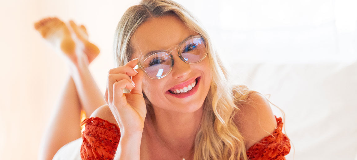 Blonde woman smiling wearing crystal champagne frame Svago clear lens glasses