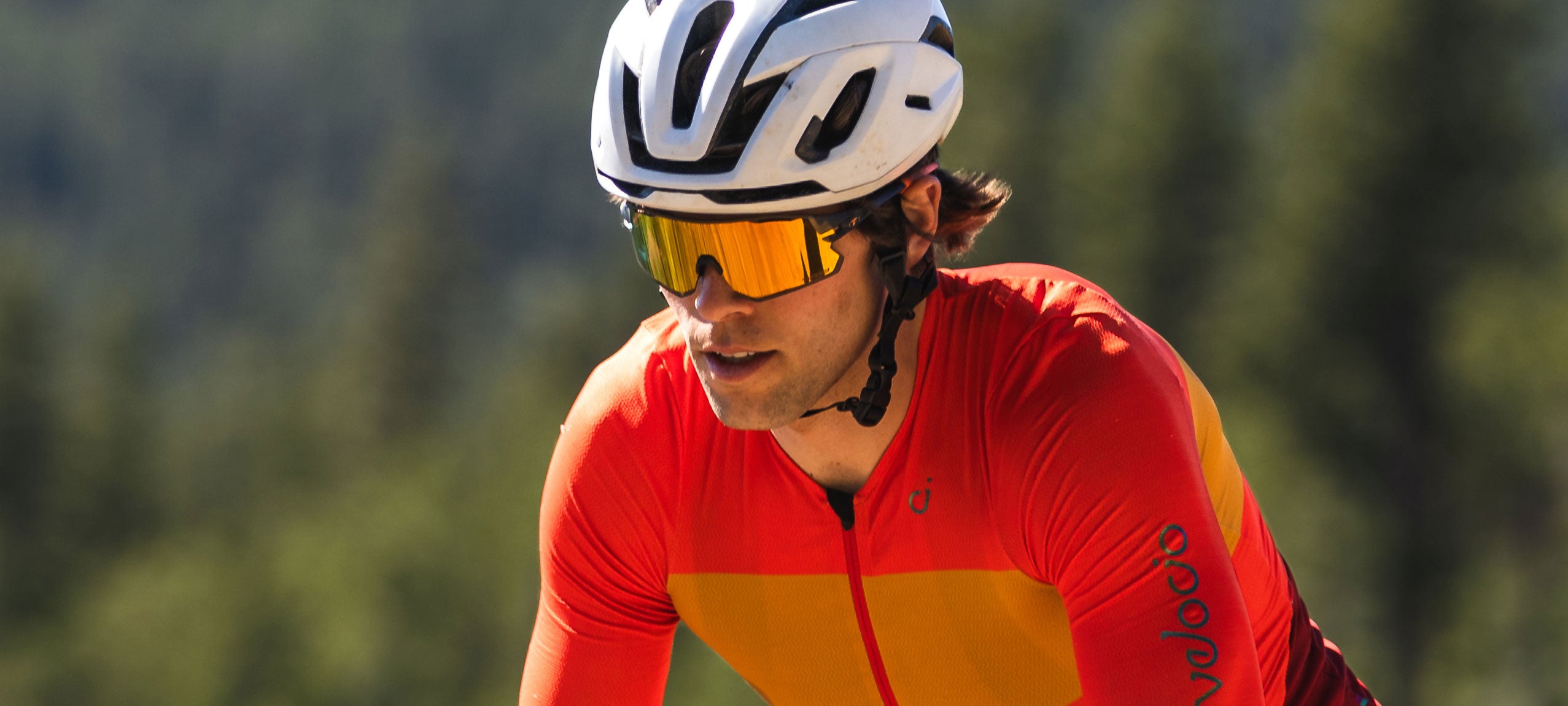 Male cyclist wearing Rail Race orange shield sunglasses