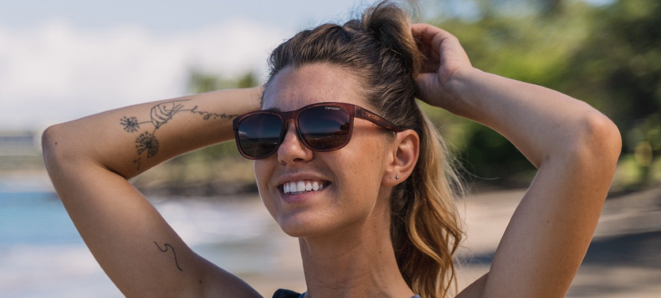 female wearing Swank XL woodgrain with brown polarized lens