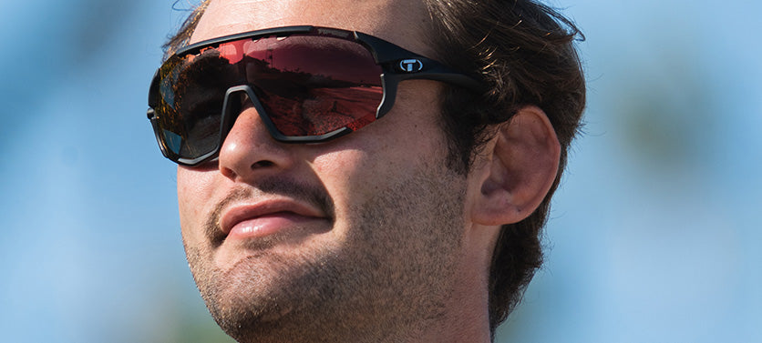 Male wearing Sledge matte black clarion red fototec photochromic sport sunglass