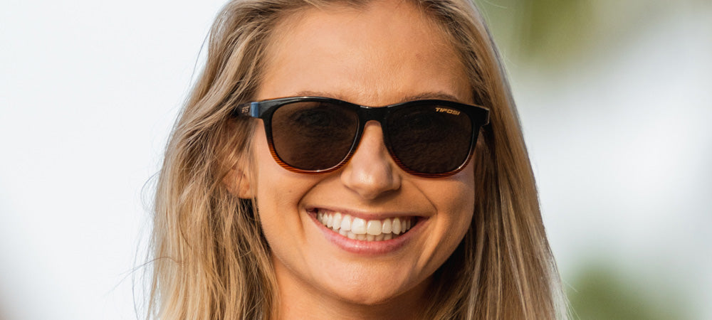 Female wearing Swank brown fade sunglasses