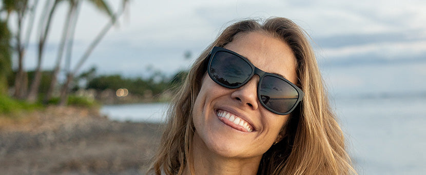 Female wearing Swank XL blackout sunglasses on the beach