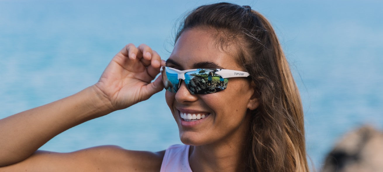 Female wearing Track white/black with Smoke Bright Blue lenses