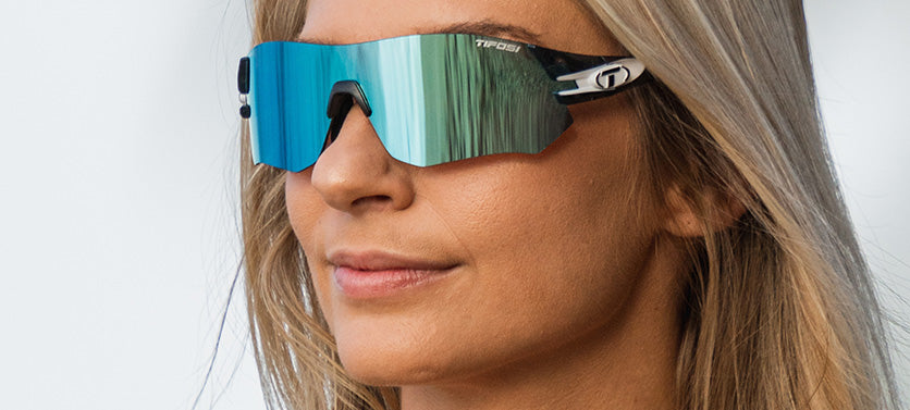 Female wearing Tsali Crystal Smoke sunglasses with Clarion Blue Mirror gray tinted lens