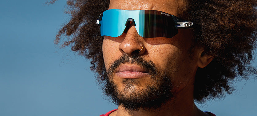 Male wearing Tsali Crystal Smoke sunglasses with Clarion Blue Mirror gray tinted lens