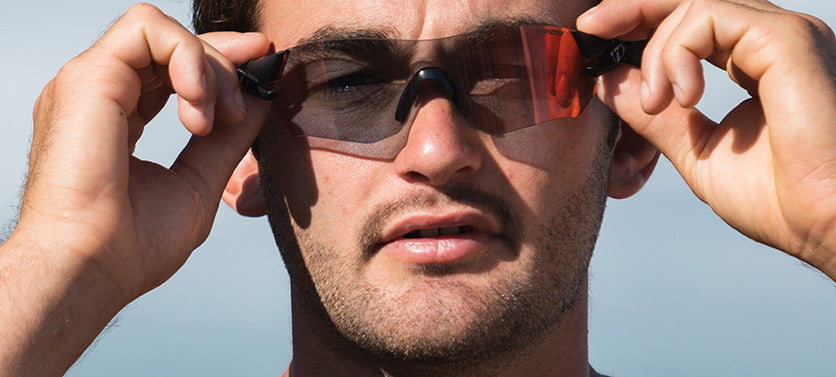 Male wearing Tsali Matte Black Clarion Red Fototec sunglasses