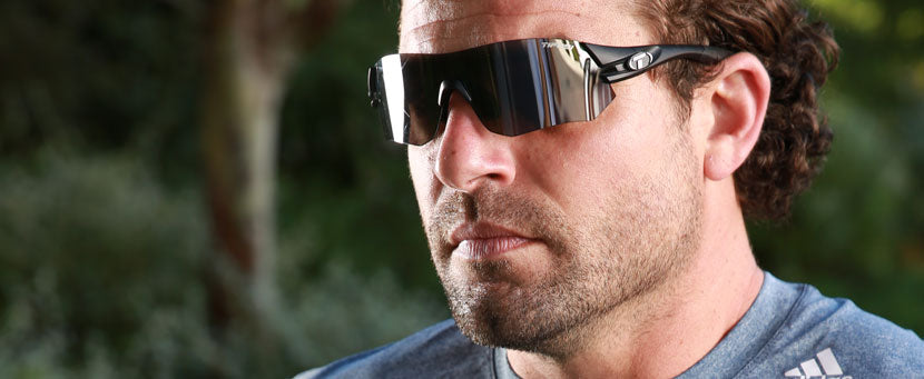 Male wearing Tsali Matte Black sunglass with a Smoke lens