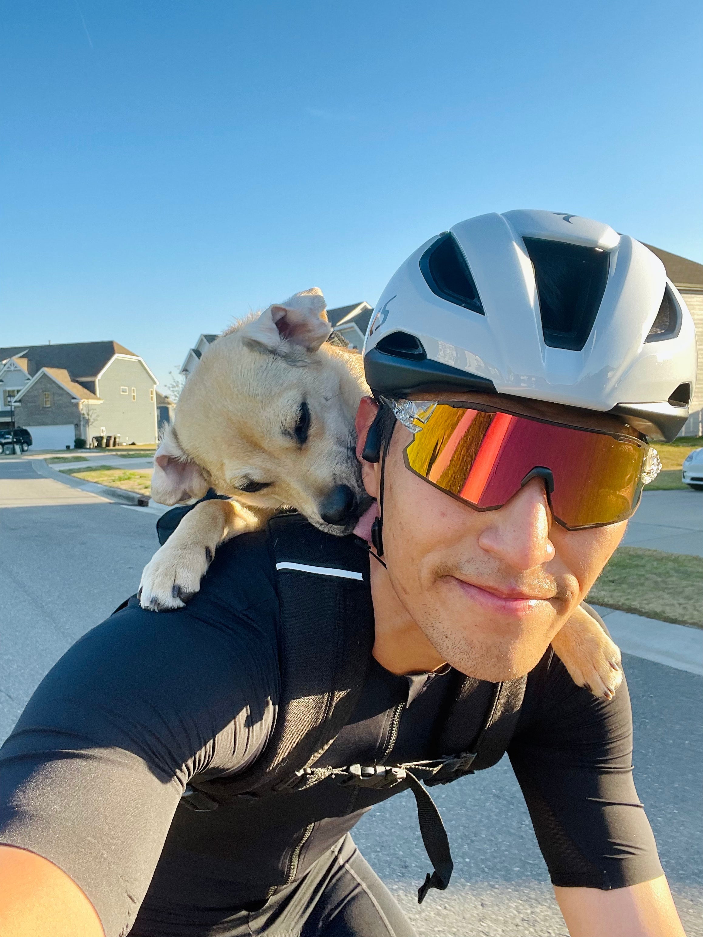 Man cycling with Tifosi sunglasses and Dog
