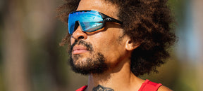 Male wearing Sledge clarion blue fototec photochromic sport sunglasses