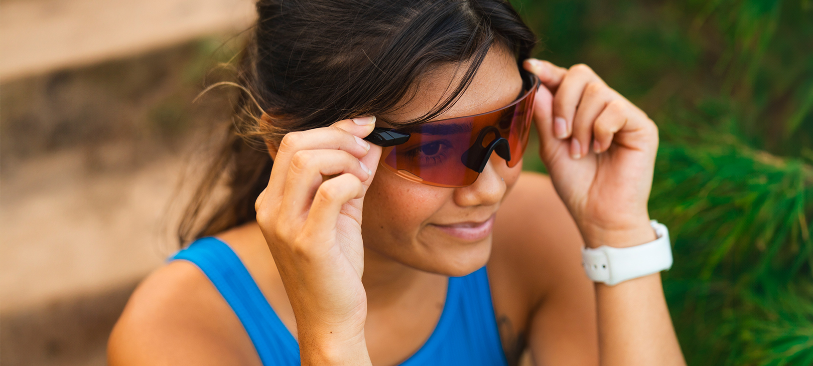 Woman wearing Vogel XC, Blackout AC Red while sitting down on steps outside