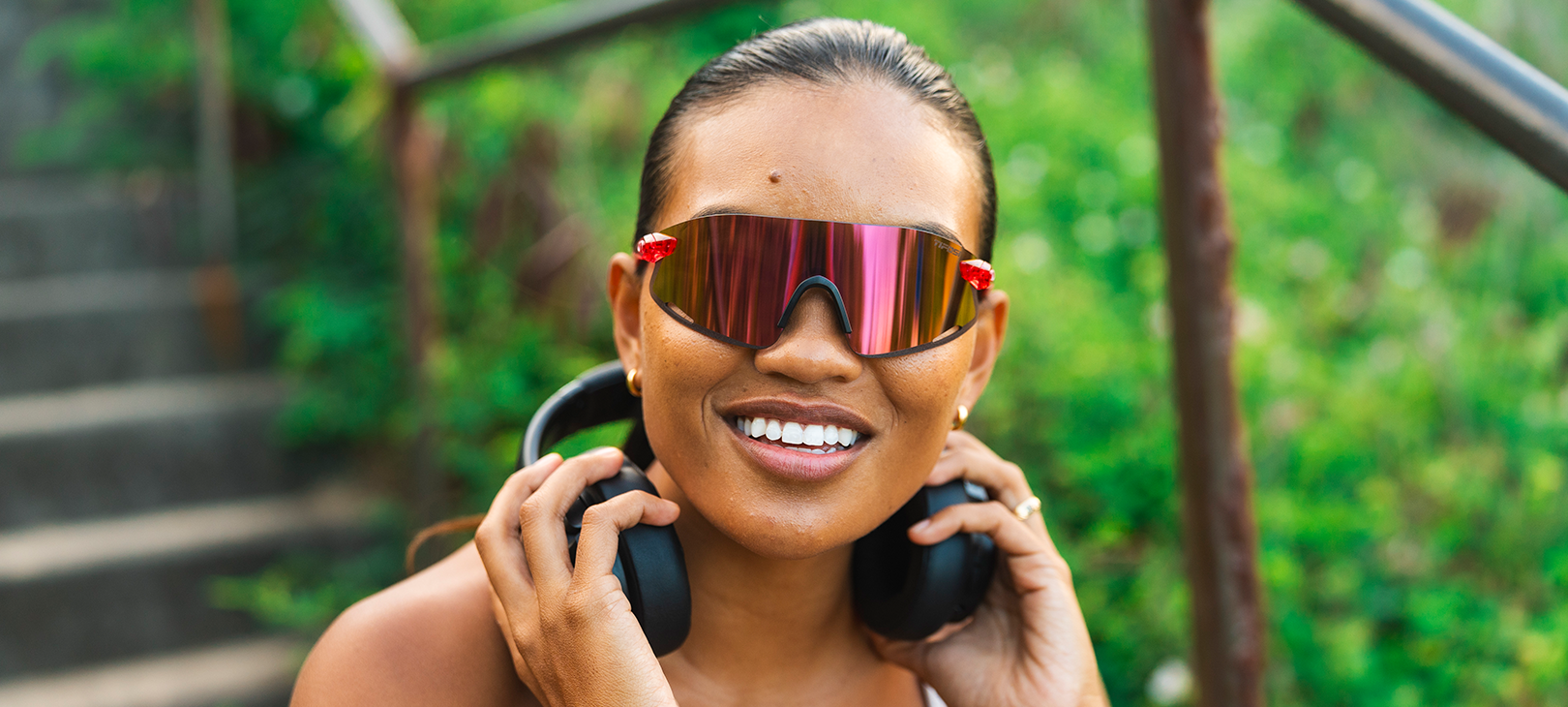 Woman wearing Vogel XC, Crystal Pink with headphones around her neck