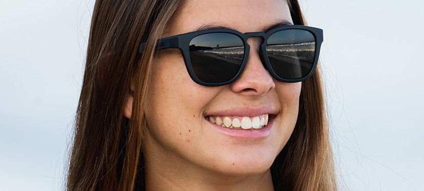 female wearing Smirk sport sunglass in blackout