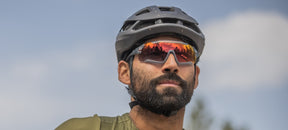 Male cyclist wearing Aethon Matte Smoke with Clarion Red Fototec lens