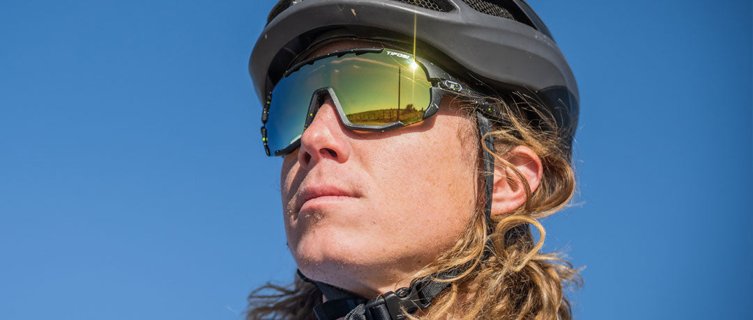 Male cyclist wearing Sledge sport sunglass in cosmic black with clarion yellow lens