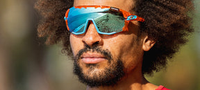 Male wearing Sledge sport sunglass in crystal orange with clarion blue lens