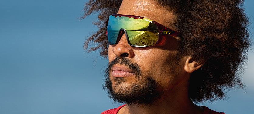 Male wearing Sledge sport sunglass in crystal red with clarion yellow lens
