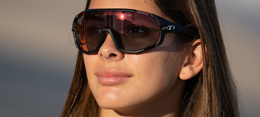 Female wearing Sledge matte black with clarion red Fototec photochromic lens sport sunglass