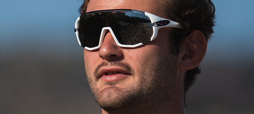 Male wearing Sledge sport sunglass in matte white with smoke lens