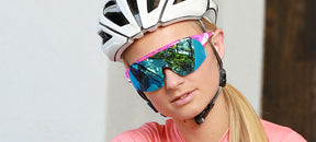 Female cyclist wearing Sledge Lite in crystal pink with clarion blue lens
