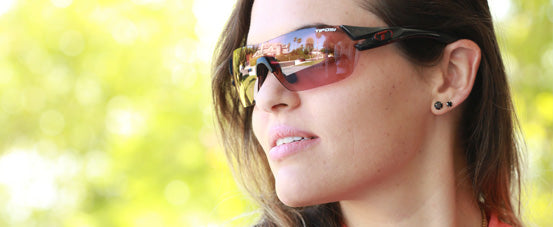 Female wearing Slice sport sunglass in crystal black with enliven bike lens