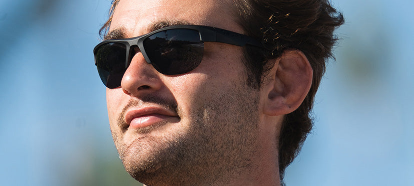 Male wearing Strikeout sport sunglasses in blackout