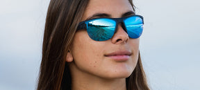 Female wearing Strikeout sport sunglasses in satin vapor