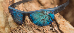 Strikeout sport sunglasses in satin vapor on a tree