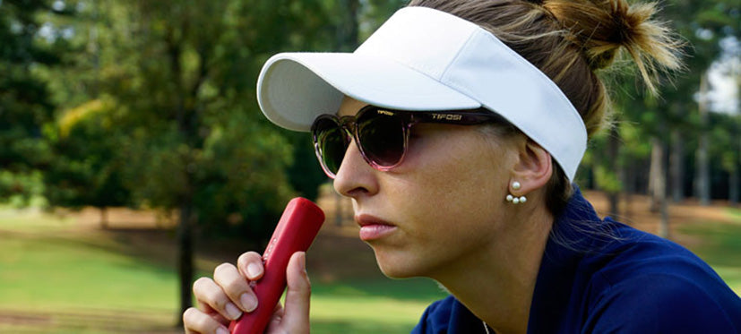 female golfer wearing Svago crystal peach blush lifestyle sport sunglasses