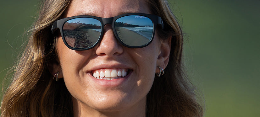 Female wearing Swank satin black sunglasses with smoke bright blue lenses