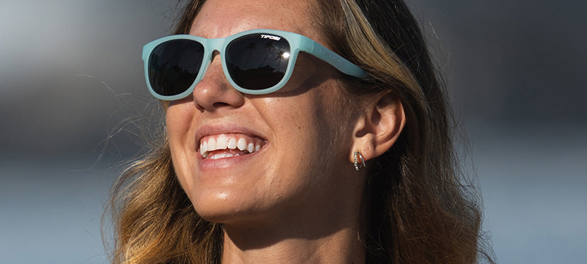 female wearing Swank satin crystal teal sunglasses