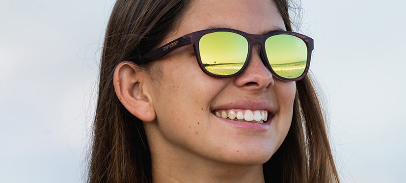 Female wearing Swank woodgrain sunglasses