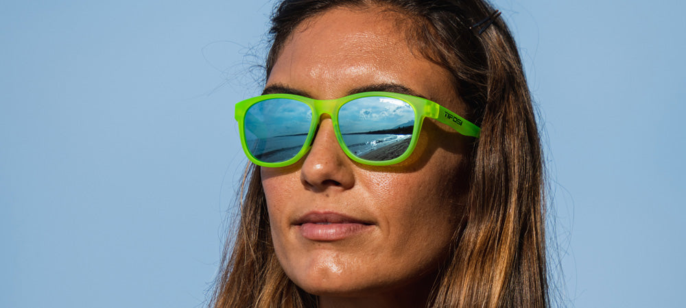 Female wearing Swank satin electric green sunglasses