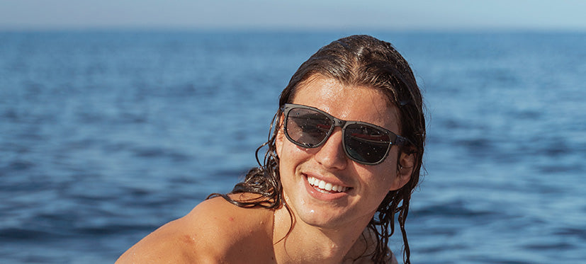 Male wearing Swank XL blackout sunglasses on the water