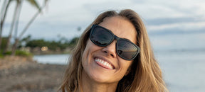 Female wearing Swank XL blackout sunglasses on a beach