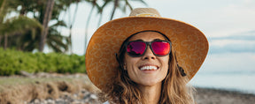 Female wearing Swank XL satin vapor sunglasses on the beach