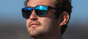 male wearing Swick blackout sky blue polarized sunglasses