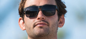 Male wearing Swick blackout sunglasses
