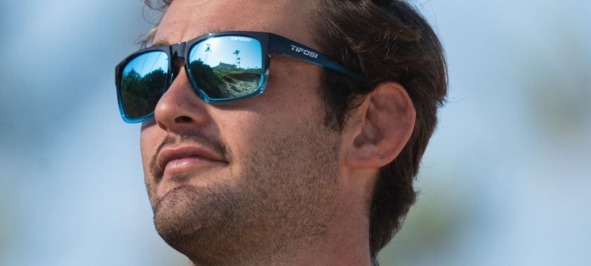 male wearing Swick onyx blue fade sunglasses