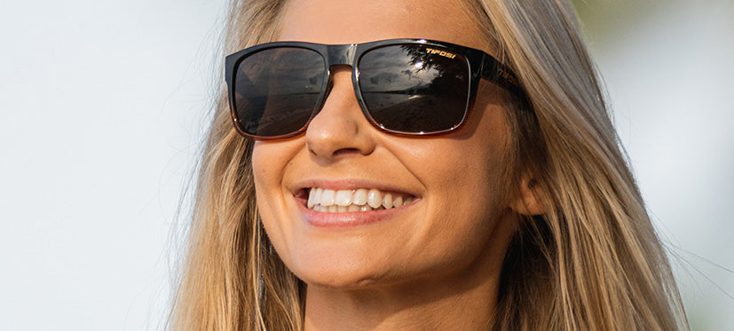 Female wearing Swick brown fade sunglasses