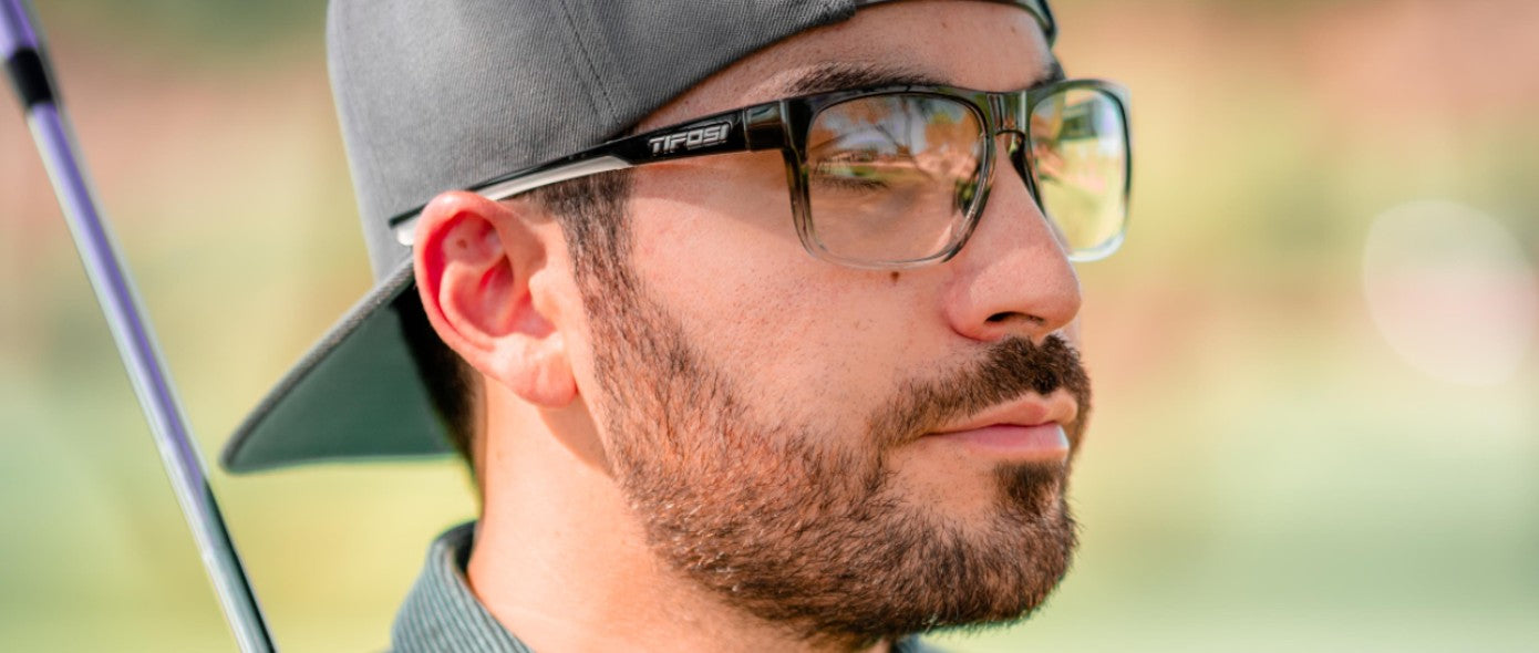 Male wearing Swick onyx fade glasses for golf