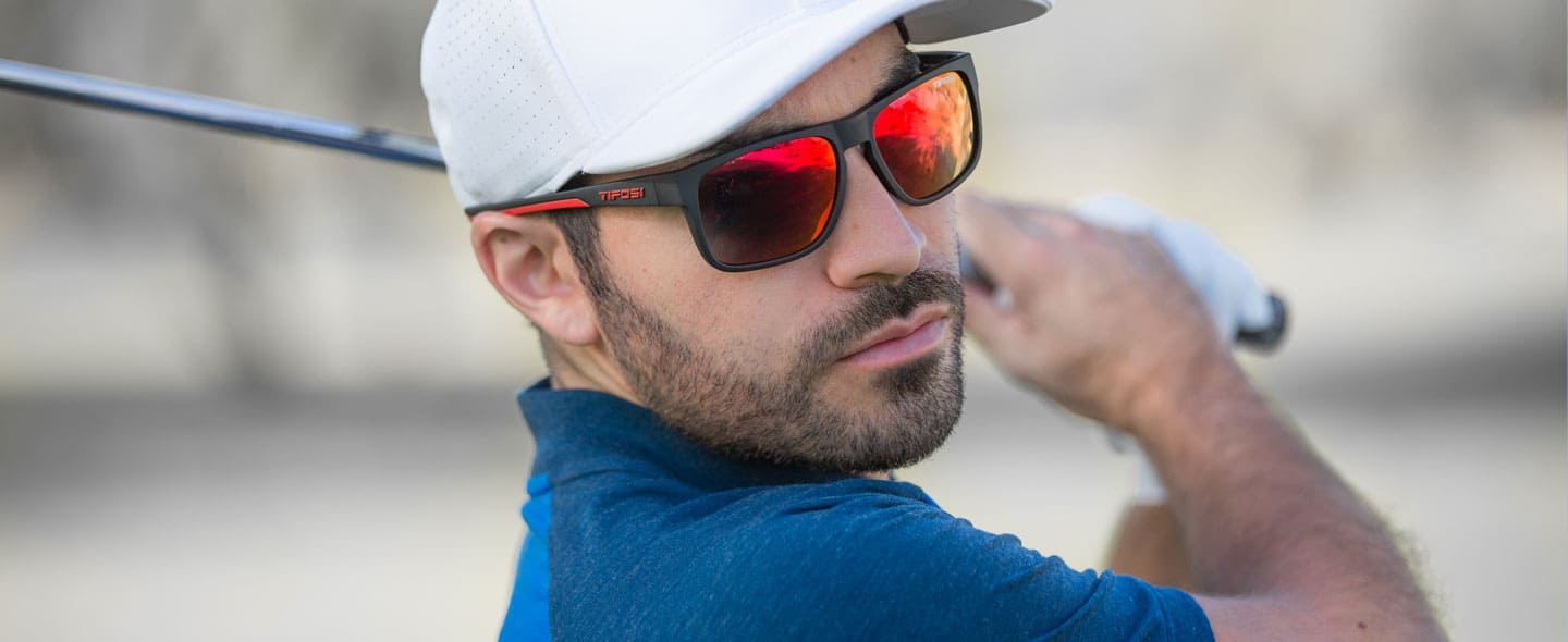Male golfer wearing Swick satin black crimson sunglasses