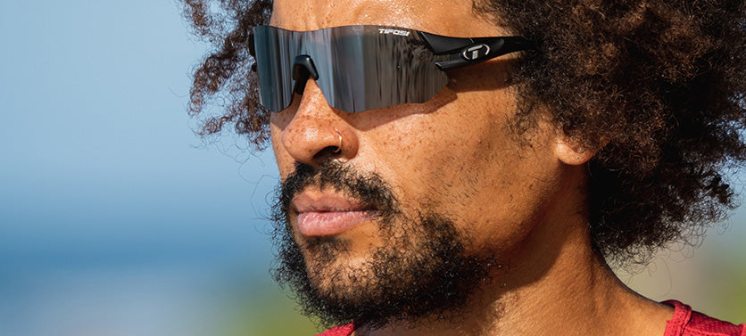 Male wearing Tsali Matte Black sunglasses with Smoke tinted lens