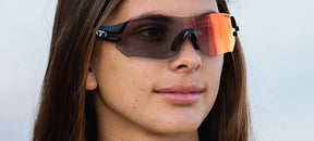 Female wearing Tsali Matte Black Clarion Red Fototec sunglasses